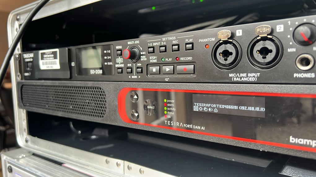 Audio equipment featuring a Tascam SD-20M recorder and Biamp Tesira Forte DSP in a professional AV setup.